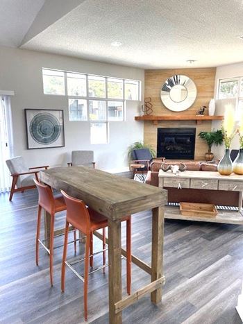 A dining room with a wooden table and chairs.